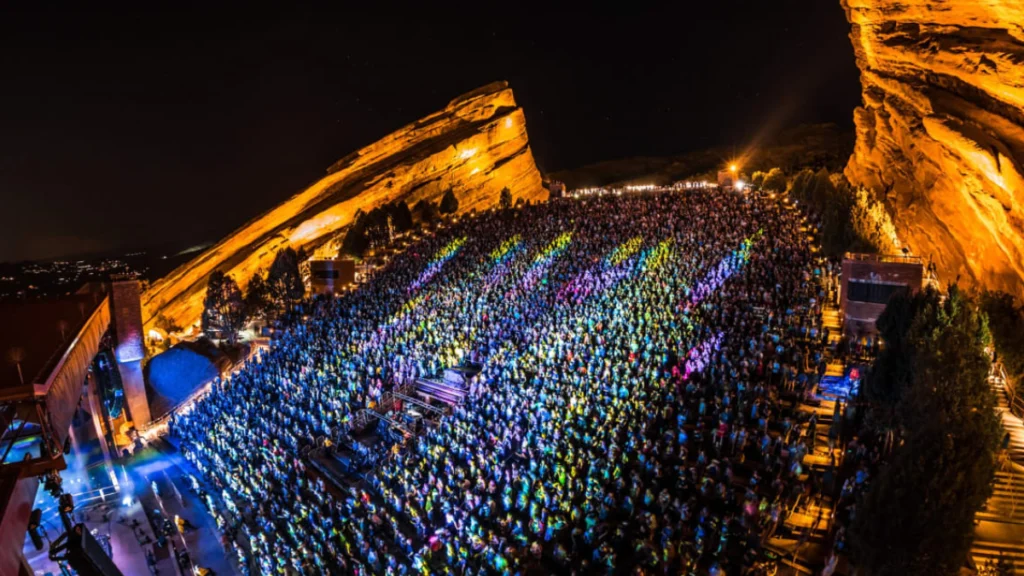 Luxury black car parked near Red Rocks Amphitheatre before a concert.