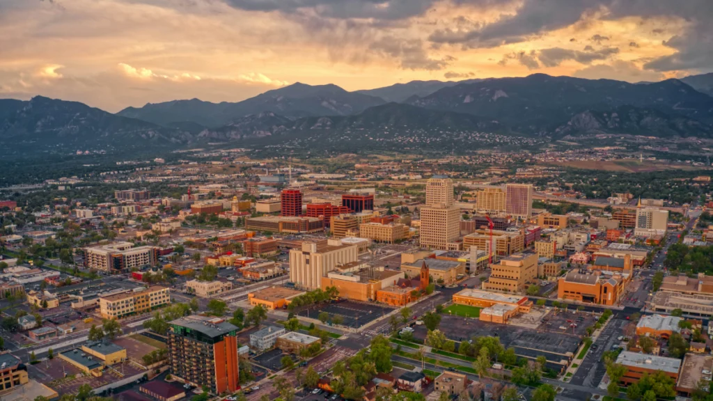 Luxury car service from Colorado Springs to Denver International Airport with mountain landscape background