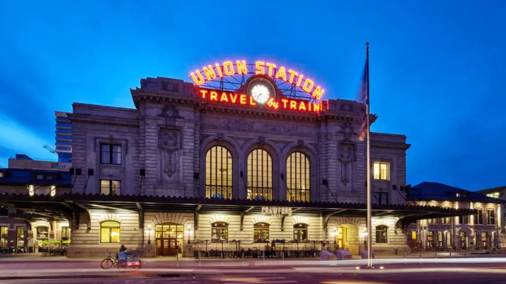 Luxury Denver airport shuttle van arriving at Union Station with passengers boarding comfortably